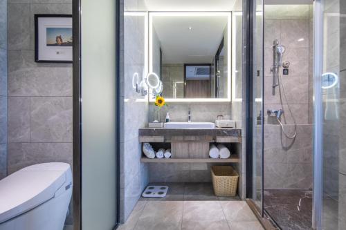 a bathroom with a shower and a sink at Atour Hotel Bantian Zhongcheng Shenzhen in Longgang