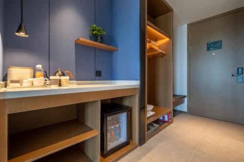a kitchen with a counter with a fireplace under it at Atour Hotel Hangzhou East Railway Station East Square in Hangzhou