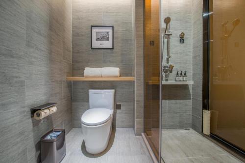 a bathroom with a toilet and a shower at Atour Hotel Guangzhou Sanyuanli-Guangzhou Baiyun Railway-Fiee Self-Service Laundry in Guangzhou