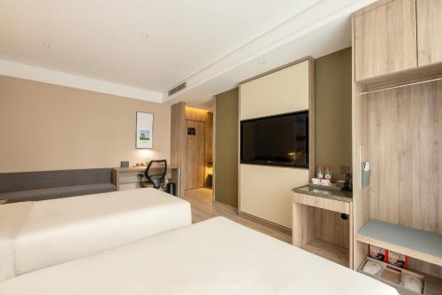 Ένα ή περισσότερα κρεβάτια σε δωμάτιο στο Atour Hotel Xi'an West Erhuan Road Tai'ao