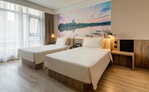 Ένα ή περισσότερα κρεβάτια σε δωμάτιο στο Atour Hotel Xi'an West Erhuan Road Tai'ao
