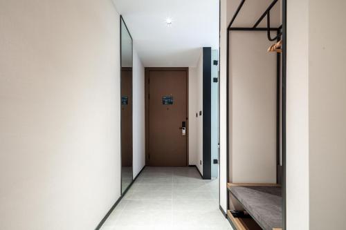 a hallway with a door and a mirror at Atour Hotel Foshan Chancheng Zhangcha in Foshan