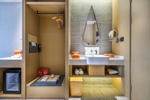 a bathroom with a sink and a mirror at Atour Hotel Dongguan Humen Avenue in Dongguan