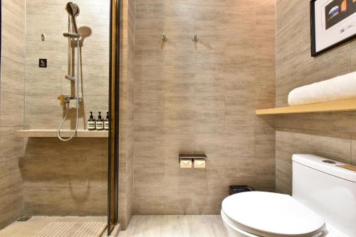 a bathroom with a shower and a toilet at Atour Hotel Wangjing SOHO in Beijing