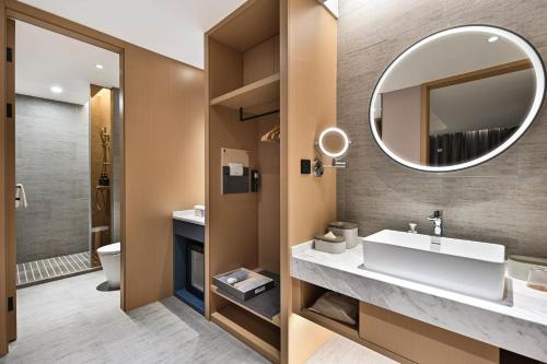 a bathroom with a sink and a mirror at Atour Hotel Kunming Dianchi Park 1903 in Kunming