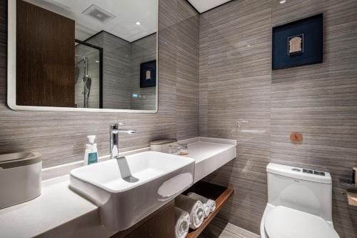 a bathroom with a sink and a toilet at Atour X Hotel Shanghai Bund East Nanjing Road Pedestrian Street in Shanghai