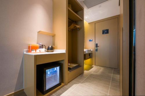 a hallway with a fireplace and a door to a bathroom at Atour Hotel Dongguan Humen Avenue in Dongguan