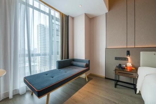 a room with a bed and a large window at Atour Hotel Dongguan Humen Avenue in Dongguan