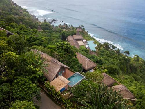 an aerial view of a house on a hill next to the ocean at Lelewatu Resort Sumba in Watukarere