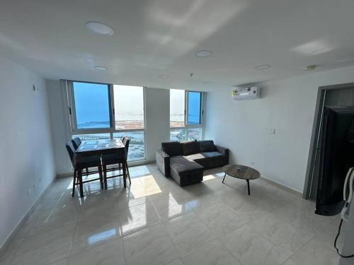 a living room with a couch and a table at Amazing Ocean View 1bed Suite in Panama City