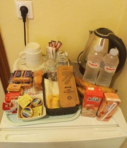 a table with food and drinks on top of it at Thiamis Guesthouse in Doliana