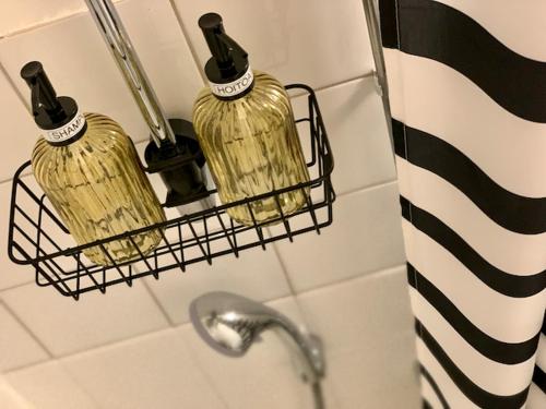 two bottles of soap on a rack in a bathroom at Kaupunkikoti in Kemi