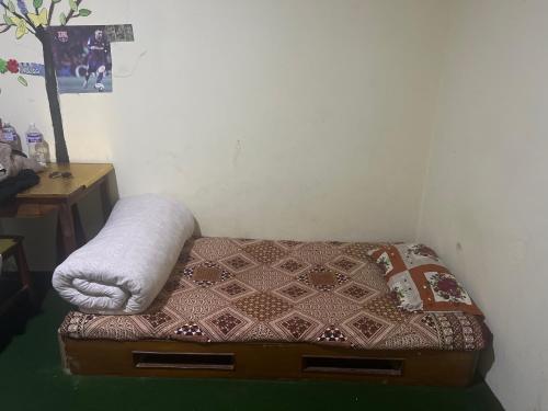 een klein bed in een hoek van een kamer bij Khatri Niwas in Tokna