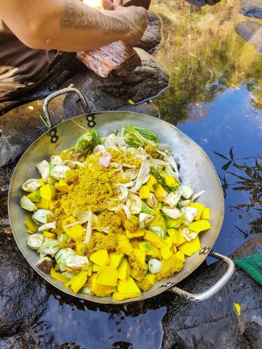a wok filled with food on top of a table at Ratanakiri Homestay & Jungle Trek in Banlung