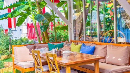 a table and chairs and a couch on a patio at Alaçatı Wellness Garden in Alacati