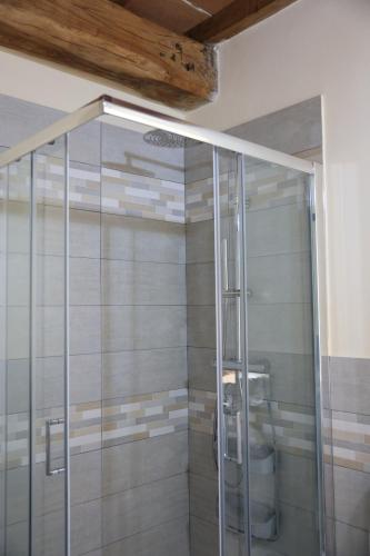 a shower with a glass door in a bathroom at Il Paradiso di Pietra in Filetto