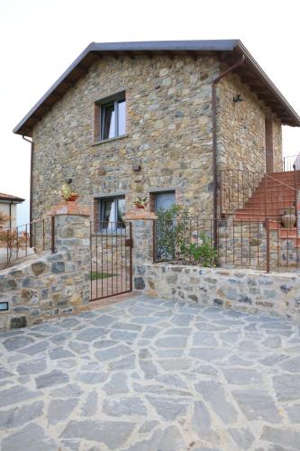 a stone house with a gate in front of it at Il Paradiso di Pietra in Filetto