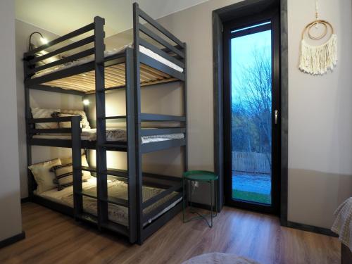 a room with two bunk beds and a window at Mokre 22 in Bielsk Podlaski