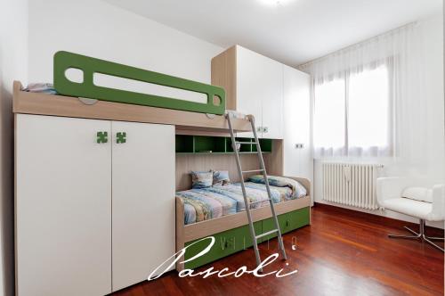a bedroom with a bunk bed with a ladder at Villino Pascoli (in centro storico) in Cesenatico