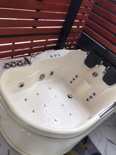 a bath tub sitting on top of a toilet at V20 Boutique Jacuzzi Hotel in Bangkok