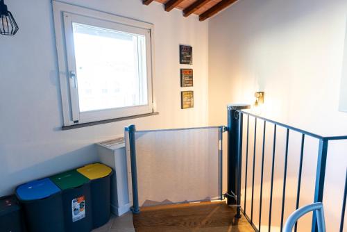 a stairway with a window and a stair railing at I BIMBI Apartments in Livorno