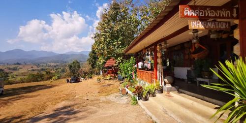 a store on a dirt road next to a street at ปายสามหมอก in Pai