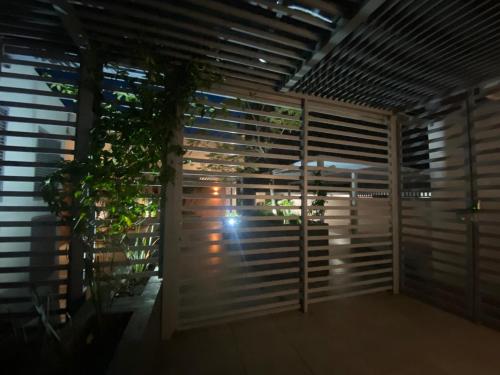 a room with wooden blinds and a plant at Centro histórico Downtown Depto completo alberca climatizada AC parking free seguridad 24 hras in Guadalajara