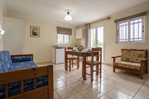 a kitchen and living room with a table and chairs at Laganas Holidays Hotel in Laganas