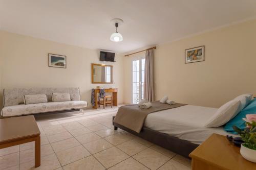 a bedroom with a bed and a couch at Laganas Holidays Hotel in Laganas