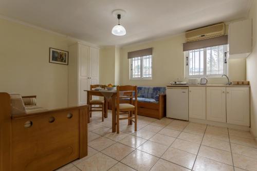 a kitchen and dining room with a table and chairs at Laganas Holidays Hotel in Laganas