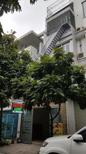 a white car parked in front of a building at Love Hotel Hà Đông HN - by BAY LUXURY in Hà Ðông