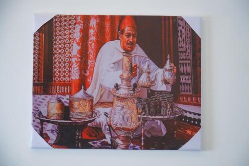 a picture of a painting of a man with candles at DAR AMR in Tangier