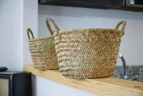 two baskets sitting on top of a wooden shelf at DAR AMR in Tangier