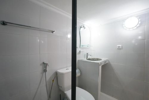 a white bathroom with a toilet and a sink at DAR AMR in Tangier