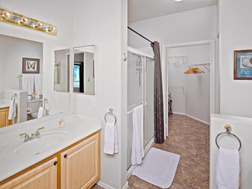 a white bathroom with a sink and a shower at Central Location, Heated Pool, Bbq, Hot Tub, More in Scottsdale