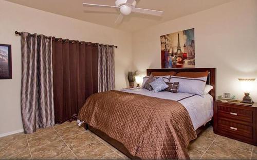 a bedroom with a bed and a ceiling fan at Central Location, Heated Pool, Bbq, Hot Tub, More in Scottsdale