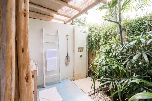 a garden room with a ladder and plants at Villa Sari Nusa Lembongan - Three bedroom Villa in Nusa Lembongan