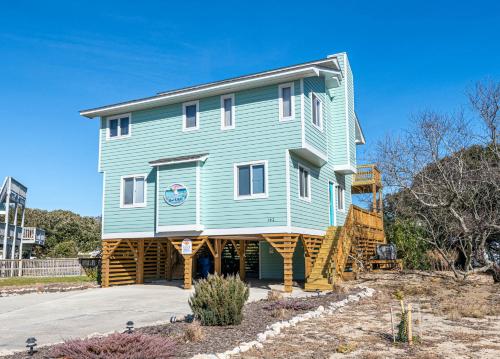 a large blue house on the side of a road at Duck R Way in Duck