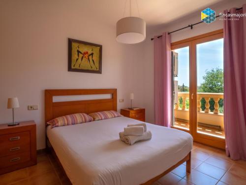 a bedroom with a bed and a large window at Casa Marco Polo in Cala Mendia