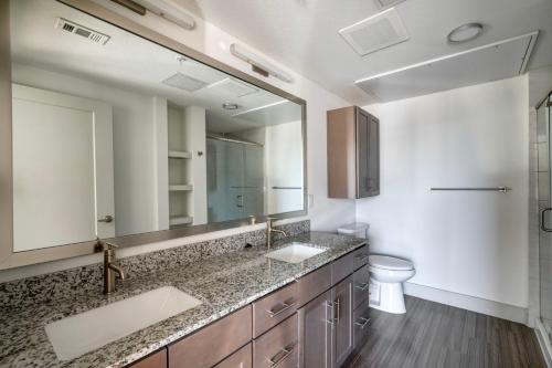 a bathroom with two sinks and a toilet at Downtown 2br w deck gym nr convention center ATX-211 in Austin