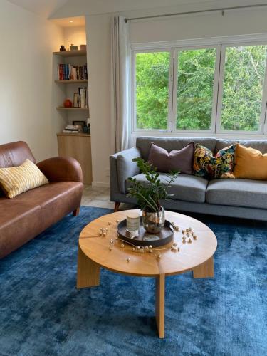 a living room with a couch and a coffee table at Blue Gum Stay in Warkworth