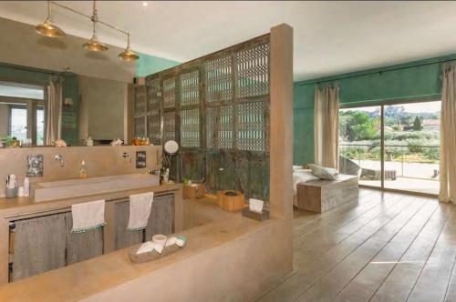 baño grande con bañera y ventana grande en LA VILLA, en Saint-Rémy-de-Provence