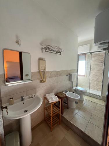 a bathroom with a sink and a toilet at Hotel L'Approdo in Brindisi