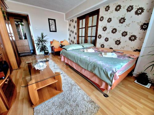 a bedroom with a bed and a table in it at Sabina Apartment in Sighişoara
