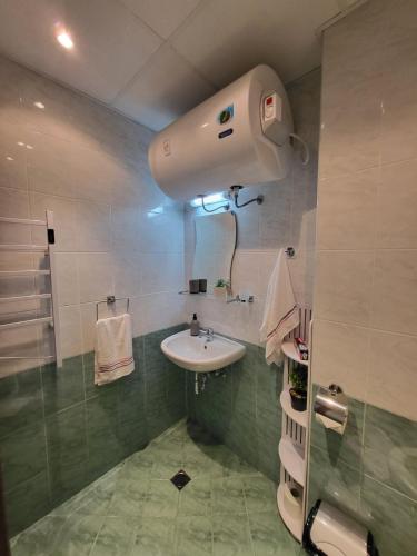 a bathroom with a white sink and a shower at Beautiful Apartment in Bansko
