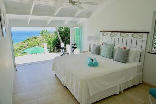 a bedroom with a bed with a view of the ocean at Lovely 3 BR Ocean View Villa in Cap Estate