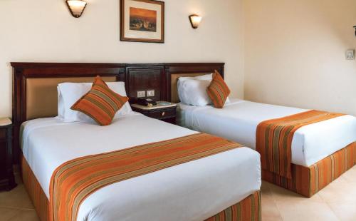 a hotel room with two beds in a room at Grand Oasis Resort in Sharm El Sheikh
