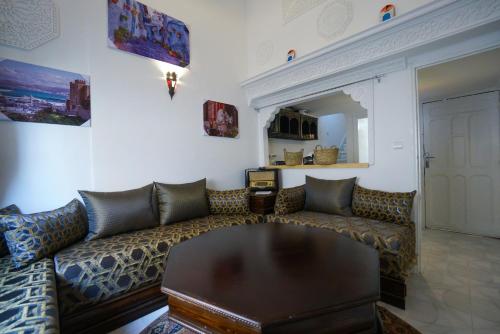 a living room with a couch and a table at DAR AMR in Tangier
