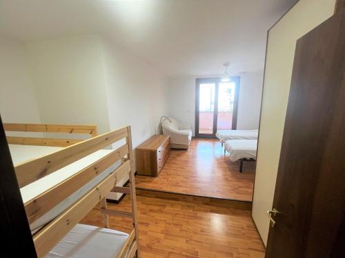 a room with two beds and a room with a hallway at Isola della Schiusa in Grado