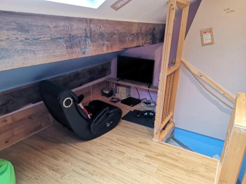 a room with a bed and a desk with a tv at The Comfy House in Huddersfield